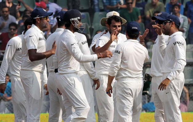 Indian cricketers celebrate fall of a wicket during the 2nd Test Match ...