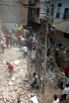 Residents look for survivors as a three storey residential building collapsed at Inderlok in Delhi on June 28, 2014. (Photo: IANS)