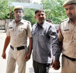 Gurgaon: Police take away Vinod, an Uber cab driver who was arrested for allegedly molesting a 21-year-old student before press in Gurgaon, on June 2, 2015. (Photo: IANS)
